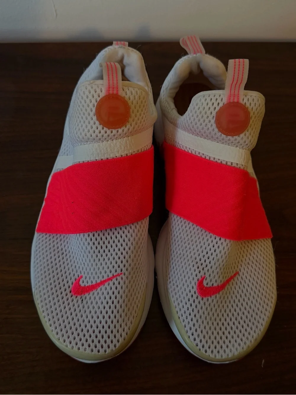 Nike Kids White Mesh Sneakers with Neon Pink Strap and Swoosh Accents